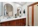 Bright bathroom featuring double vanity, marble countertop, modern fixtures, and access through glass doors at 8215 E Cypress St, Scottsdale, AZ 85257