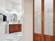 Bathroom view through french doors reveals marble flooring, a glass shower, and a white countertop vanity at 8215 E Cypress St, Scottsdale, AZ 85257