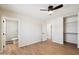 Bright bedroom with wood floors, a ceiling fan, and access to a bathroom and closet space at 8215 E Cypress St, Scottsdale, AZ 85257