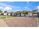 Single-story home featuring a gravel yard, attached garage, and chairs on a covered patio at 8215 E Cypress St, Scottsdale, AZ 85257