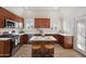 Kitchen featuring a center island with seating, stainless steel appliances, and marble countertops at 8215 E Cypress St, Scottsdale, AZ 85257