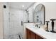 Modern tiled shower with glass door, rainfall showerhead, and mosaic tile flooring at 8215 E Cypress St, Scottsdale, AZ 85257