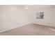 Bright bedroom featuring neutral carpeting, ceiling fan, and a window that provides natural light at 8588 E Indian School Rd # G, Scottsdale, AZ 85251