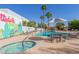 Inviting community pool area with comfortable lounge chairs, tropical landscaping, and a hot tub at 8588 E Indian School Rd # G, Scottsdale, AZ 85251