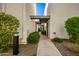 Community entryway with green landscaping and unit designators above at 8588 E Indian School Rd # G, Scottsdale, AZ 85251