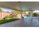 A covered patio overlooks a large pool with a view of the backyard at 8626 E San Miguel E Ave, Scottsdale, AZ 85250