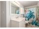 Stylish bathroom featuring a white vanity, marble countertop, and decorative shower curtain at 8626 E San Miguel E Ave, Scottsdale, AZ 85250