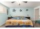 Comfortable bedroom featuring a ceiling fan, decorative wall art, and wood-look flooring at 8626 E San Miguel E Ave, Scottsdale, AZ 85250