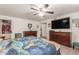 Primary bedroom featuring a ceiling fan, mounted tv, wood-look floors, and dual dressers at 8626 E San Miguel E Ave, Scottsdale, AZ 85250