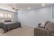 Cozy bedroom with soft blue walls, a ceiling fan, and a comfortable gray couch at 8626 E San Miguel E Ave, Scottsdale, AZ 85250