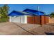 This home features a side view of the garage, with a wood gate leading to the back yard at 8626 E San Miguel E Ave, Scottsdale, AZ 85250