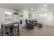 Open-concept living room featuring a gray sofa, table, and access to the bedroom and bathroom at 8626 E San Miguel E Ave, Scottsdale, AZ 85250