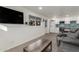 Open-concept living room featuring a wall-mounted TV, gray sofa, and access to the kitchen at 8626 E San Miguel E Ave, Scottsdale, AZ 85250