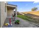 Shallow gravel backyard, covered patio with fan, and block wall for privacy at 864 W Blue Ridge Dr, San Tan Valley, AZ 85140