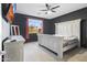 Bedroom features dark accent wall, ceiling fan, and rustic furniture with a window overlooking backyard at 864 W Blue Ridge Dr, San Tan Valley, AZ 85140