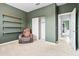 Olive-green bedroom featuring a relaxing chair, shelves, closet, and doorway to another room at 864 W Blue Ridge Dr, San Tan Valley, AZ 85140