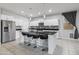 Stylish kitchen featuring a large island, white cabinets, a stainless steel refrigerator, and bar stool seating at 864 W Blue Ridge Dr, San Tan Valley, AZ 85140