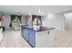 Modern kitchen and living room featuring tile floors, a kitchen island, and stainless appliances at 864 W Blue Ridge Dr, San Tan Valley, AZ 85140