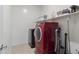 Bright laundry room with red washer and dryer, shelving and tile floor at 864 W Blue Ridge Dr, San Tan Valley, AZ 85140