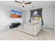 Modern living room with a cozy sofa, ceiling fan, and a wall-mounted TV displaying desert scenery at 864 W Blue Ridge Dr, San Tan Valley, AZ 85140