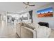 Open concept living room flowing into the kitchen, features a plush sofa and a wall-mounted TV at 864 W Blue Ridge Dr, San Tan Valley, AZ 85140