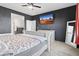 Bedroom with a rustic white bed frame, dark walls, a ceiling fan, and a wall-mounted TV at 864 W Blue Ridge Dr, San Tan Valley, AZ 85140