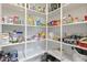 Organized walk-in pantry with white shelving stocked with food and household items at 864 W Blue Ridge Dr, San Tan Valley, AZ 85140