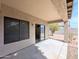 Back patio featuring a covered porch and sliding glass door access to the home's interior at 8861 W Paradise Dr, Peoria, AZ 85345