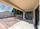 View of the gravel-covered backyard with a covered porch and a block fence at 8861 W Paradise Dr, Peoria, AZ 85345