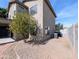 Back exterior view of the house, featuring a patio, gravel landscaping, and AC Unit at 8861 W Paradise Dr, Peoria, AZ 85345