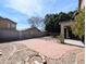 View of the backyard with gravel landscaping, a brick patio, and block fence at 8861 W Paradise Dr, Peoria, AZ 85345