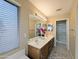 Bathroom featuring a double sink vanity, large mirror, stylish decor, and natural light at 8861 W Paradise Dr, Peoria, AZ 85345