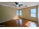 Bright bedroom featuring three windows offering ample natural light and wood-look floors at 8861 W Paradise Dr, Peoria, AZ 85345