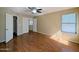 Spacious bedroom with a ceiling fan, wood floor, and bright natural light from the window at 8861 W Paradise Dr, Peoria, AZ 85345