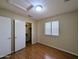 Bedroom with a closet, window, and wood floors creating a relaxing and functional space at 8861 W Paradise Dr, Peoria, AZ 85345