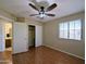 This bedroom has a sliding-door closet and a fan at 8861 W Paradise Dr, Peoria, AZ 85345