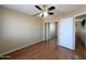 Standard bedroom with a sliding mirror closet and wood floors at 8861 W Paradise Dr, Peoria, AZ 85345