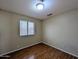 Bedroom with a wood floor, window, and neutral walls providing a serene and comfortable space at 8861 W Paradise Dr, Peoria, AZ 85345