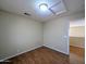 This is a bedroom with a light-colored wall, a light and a wood floor at 8861 W Paradise Dr, Peoria, AZ 85345