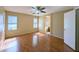 Spacious main bedroom featuring wood floors, natural light, and an en suite bathroom at 8861 W Paradise Dr, Peoria, AZ 85345