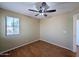 A bedroom with a light-colored wall, fan and a wood floor at 8861 W Paradise Dr, Peoria, AZ 85345