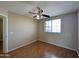 A bedroom with a fan, window and light colored wall at 8861 W Paradise Dr, Peoria, AZ 85345