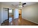 Bedroom with a sliding mirror door closet and wood floors at 8861 W Paradise Dr, Peoria, AZ 85345