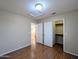 Bedroom with a view into closet, wood floors, and neutral walls creating inviting and calming atmosphere at 8861 W Paradise Dr, Peoria, AZ 85345