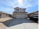 Exterior view of a two-story home with a driveway and attached two-car garage at 8861 W Paradise Dr, Peoria, AZ 85345