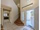 Entryway foyer with tile flooring, stairs to the second floor, and kitchen access at 8861 W Paradise Dr, Peoria, AZ 85345