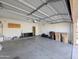 An ample garage space with garage door, storage options, and neutral paint at 8861 W Paradise Dr, Peoria, AZ 85345