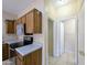 View of kitchen with stainless appliances and doorway leading to a bathroom at 8861 W Paradise Dr, Peoria, AZ 85345