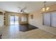 Living room with a ceiling fan, tile flooring, and natural light from the sliding glass doors at 8861 W Paradise Dr, Peoria, AZ 85345