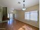 Open-concept living space with wood floors, staircase, and ample natural light at 8861 W Paradise Dr, Peoria, AZ 85345